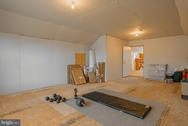 exercise room featuring vaulted ceiling