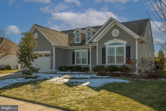 view of front of house with a garage and a front lawn