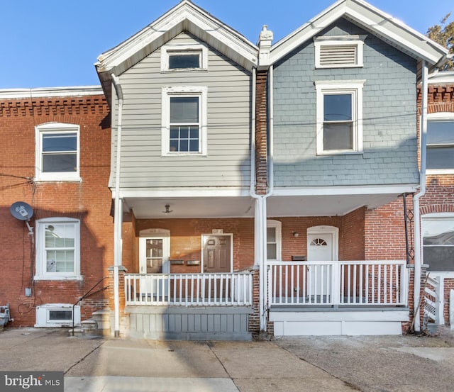 townhome / multi-family property with a porch