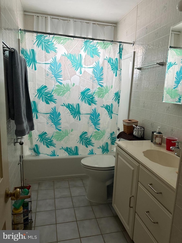 1901 Walnut Ave, Dundalk, MD 21222 - full bath with tile patterned flooring, vanity, shower / bathtub combination with curtain, tile walls, and toilet