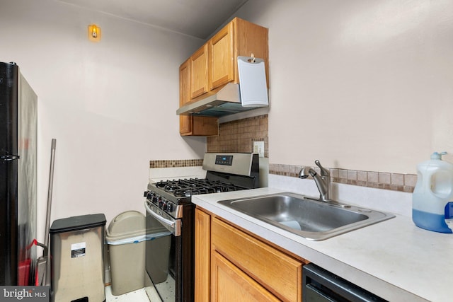 kitchen featuring black appliances, decorative backsplash, and sink