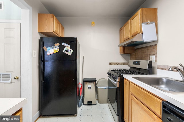 kitchen featuring sink, tasteful backsplash, and black appliances