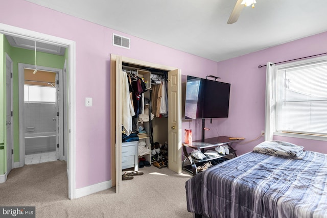 carpeted bedroom featuring multiple windows, a closet, and ceiling fan