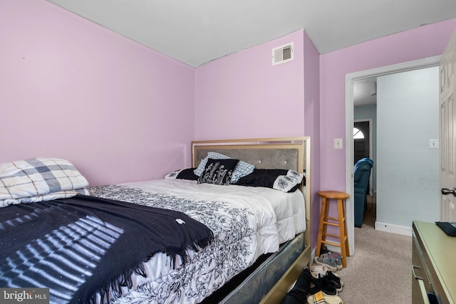 bedroom with light colored carpet