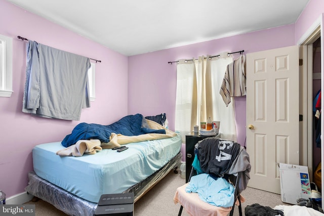 bedroom with carpet flooring and multiple windows