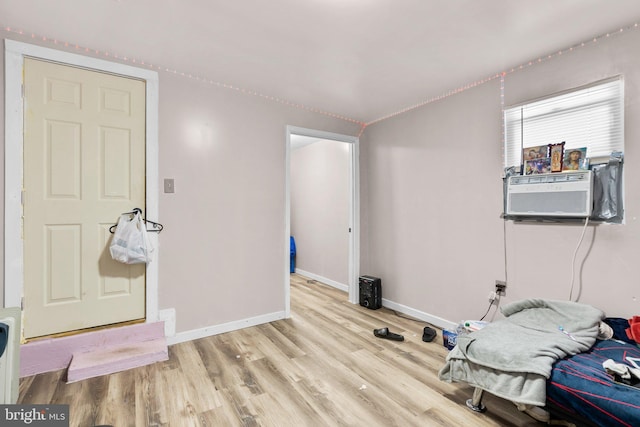 interior space with light hardwood / wood-style floors and cooling unit