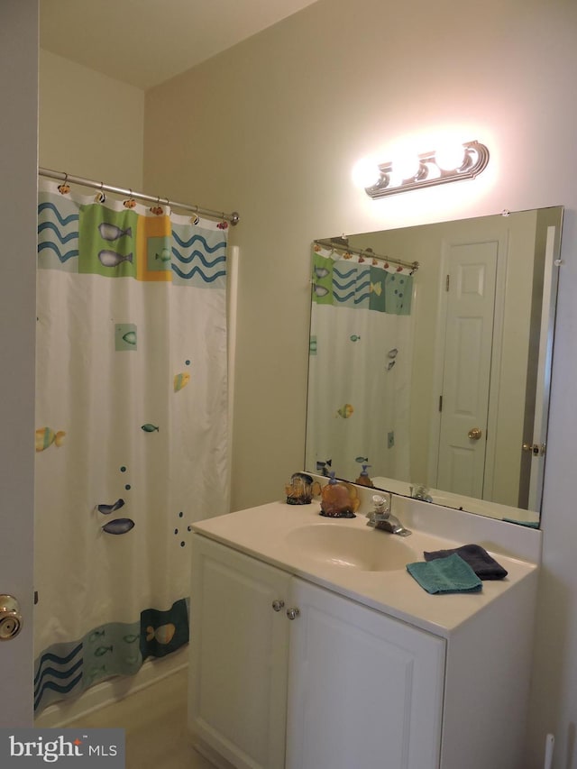 bathroom featuring vanity and shower / bath combination with curtain