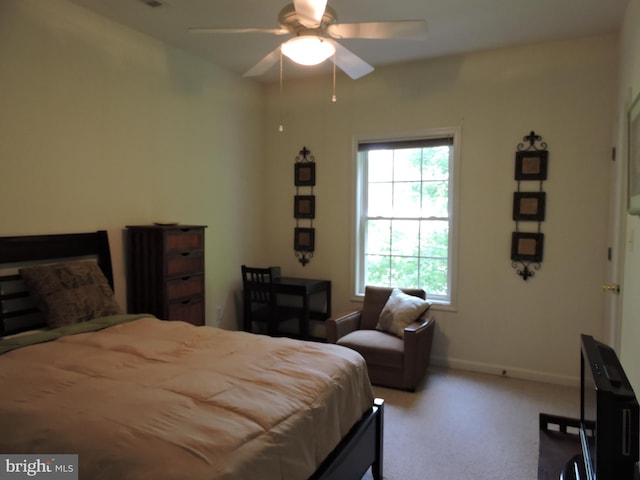 bedroom with ceiling fan and light carpet