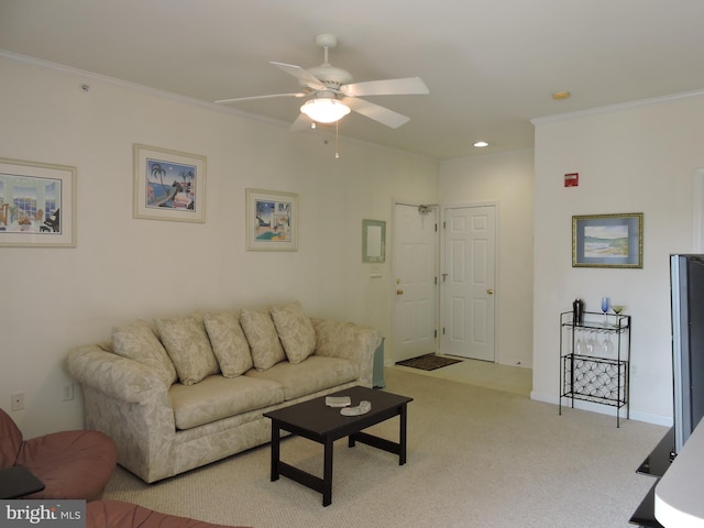 carpeted living room with ceiling fan and ornamental molding