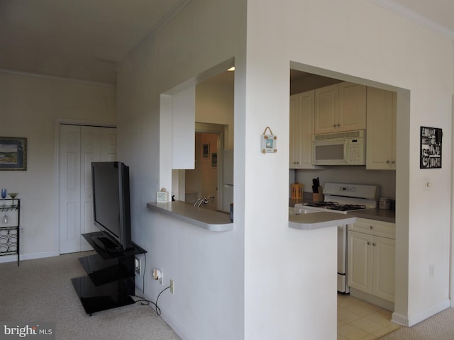 kitchen featuring light carpet, white appliances, and ornamental molding