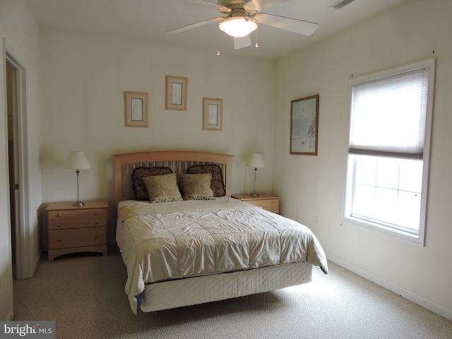 bedroom with carpet, ceiling fan, and multiple windows