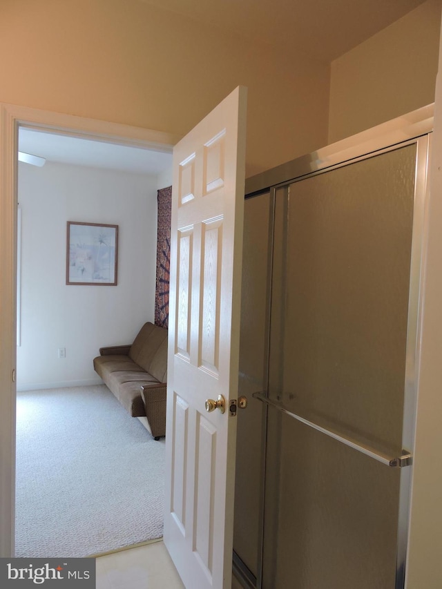 bathroom with a shower with door