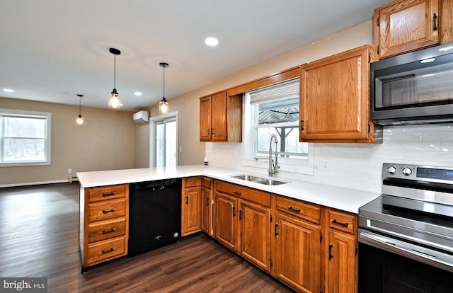 kitchen featuring kitchen peninsula, electric range, sink, black dishwasher, and hanging light fixtures