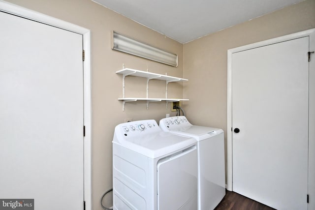 clothes washing area with washer and clothes dryer and dark hardwood / wood-style floors