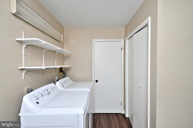 laundry room with dark hardwood / wood-style flooring and washing machine and dryer