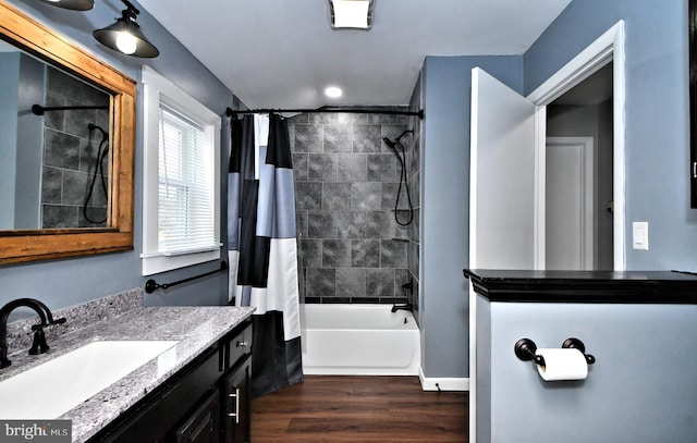 bathroom with vanity, shower / bath combo with shower curtain, and hardwood / wood-style flooring