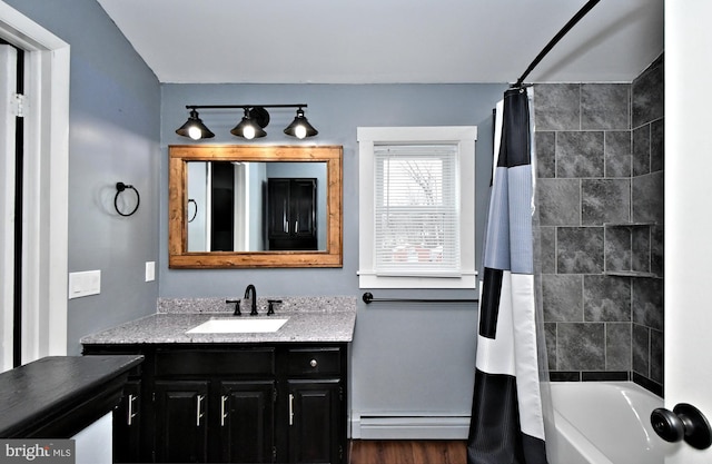 bathroom with shower / bath combo with shower curtain, baseboard heating, hardwood / wood-style floors, and vanity