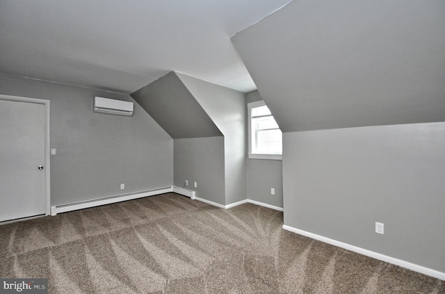 additional living space with a baseboard heating unit, vaulted ceiling, carpet flooring, and a wall mounted air conditioner