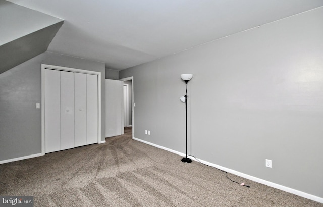 unfurnished bedroom with a closet and carpet flooring