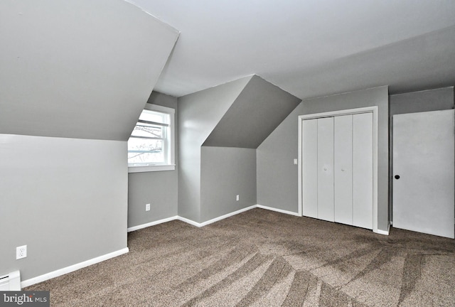 additional living space featuring vaulted ceiling and carpet