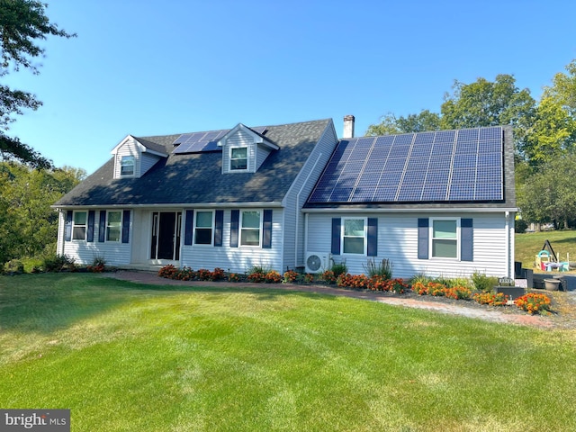 cape cod home featuring ac unit, a front lawn, and solar panels