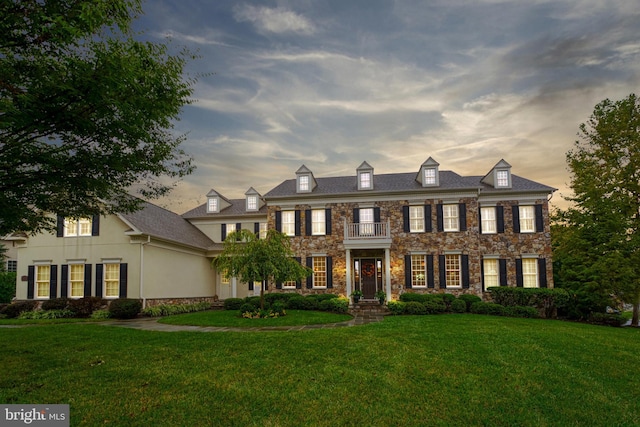 colonial home with a lawn