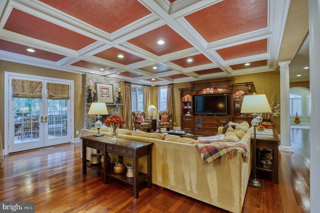 living room with decorative columns, coffered ceiling, dark wood-type flooring, and a wealth of natural light