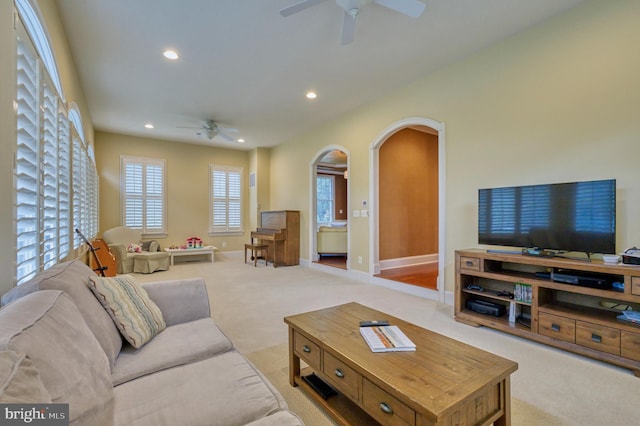 carpeted living room featuring ceiling fan