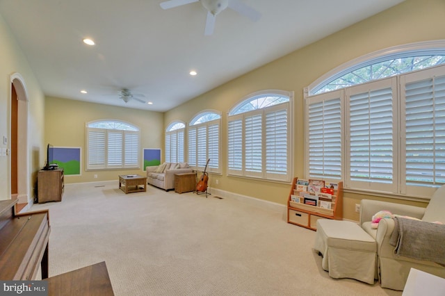 game room with ceiling fan and light carpet