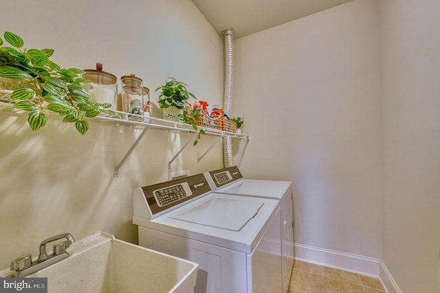 washroom featuring separate washer and dryer, sink, and light tile patterned flooring