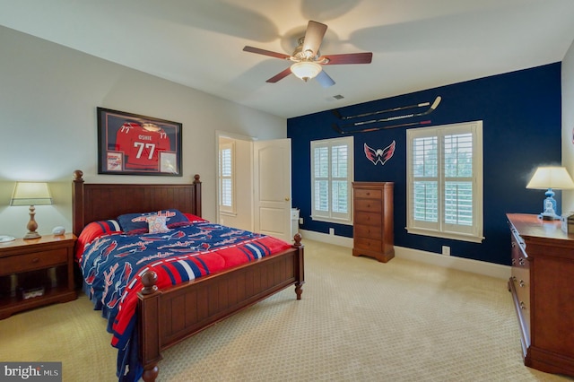 bedroom featuring light carpet and ceiling fan