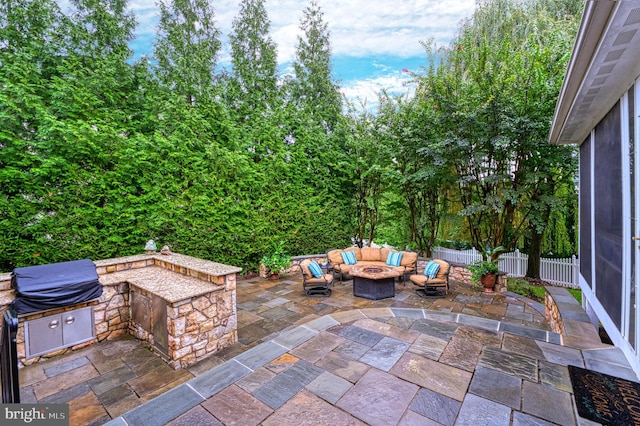 view of patio featuring a grill, outdoor lounge area, and an outdoor kitchen