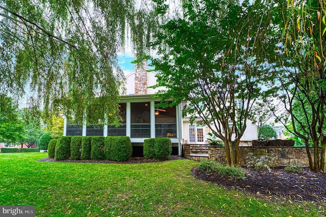 exterior space with a front lawn and a sunroom