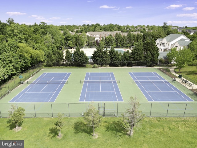 view of sport court with a yard