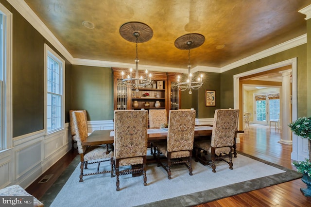 dining area featuring ornate columns, ornamental molding, dark hardwood / wood-style floors, and a wealth of natural light