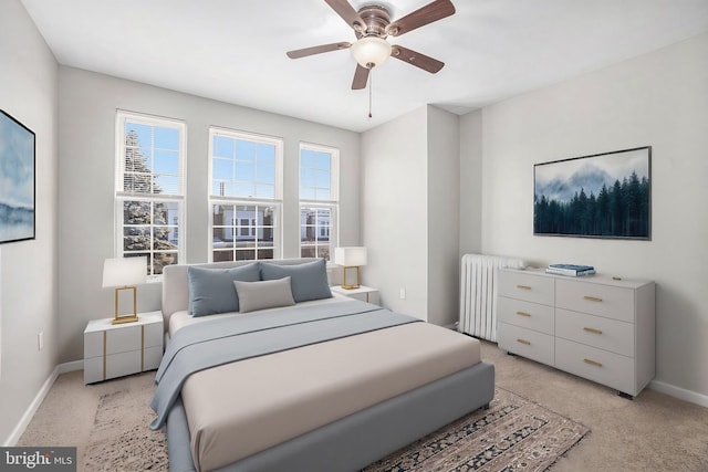 carpeted bedroom featuring ceiling fan and radiator