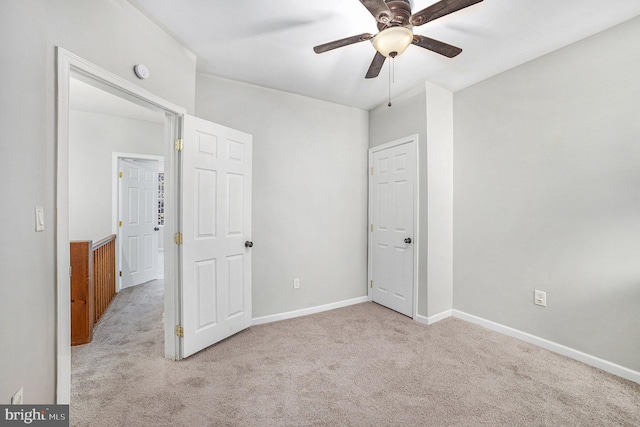 unfurnished bedroom featuring ceiling fan and light colored carpet