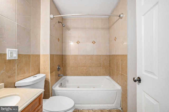 full bathroom with tiled shower / bath combo, vanity, tile walls, and toilet