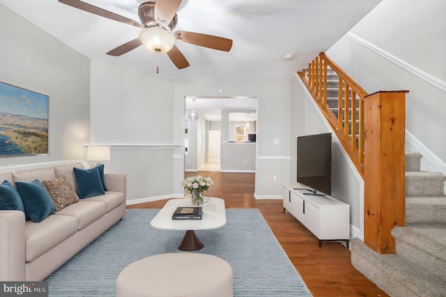 living room featuring wood-type flooring and ceiling fan