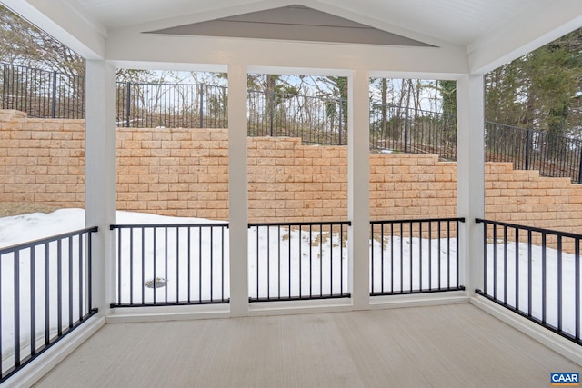 unfurnished sunroom with a wealth of natural light and vaulted ceiling