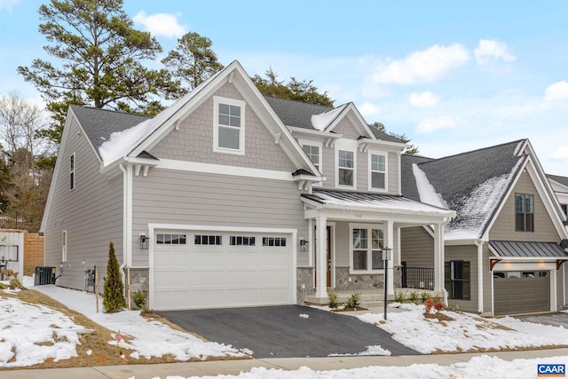 view of front facade with a porch, a garage, and cooling unit