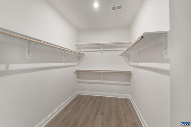 spacious closet featuring hardwood / wood-style floors