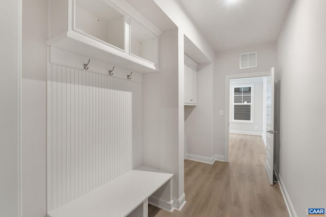 mudroom with light hardwood / wood-style floors