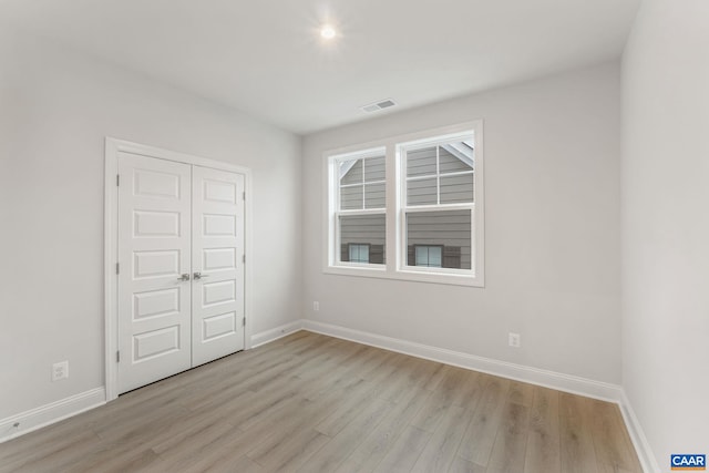 interior space with light wood-type flooring and a closet