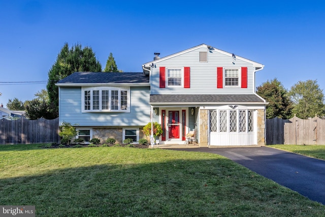 tri-level home featuring a front lawn