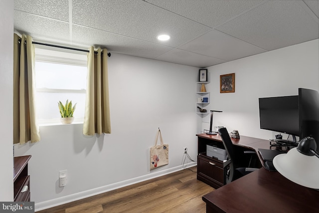 office area featuring hardwood / wood-style flooring and a paneled ceiling