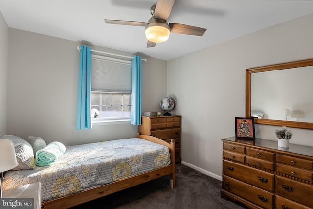 bedroom with ceiling fan and dark carpet