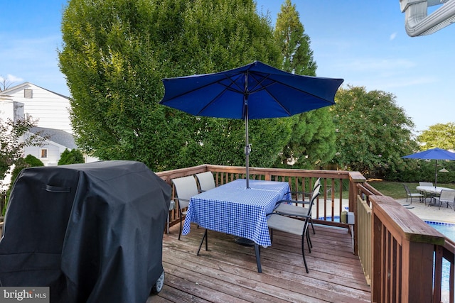 wooden terrace featuring grilling area