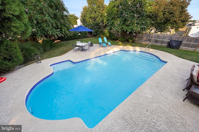 view of pool with a yard and a patio