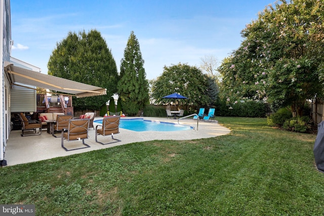 view of swimming pool featuring a patio area and a lawn